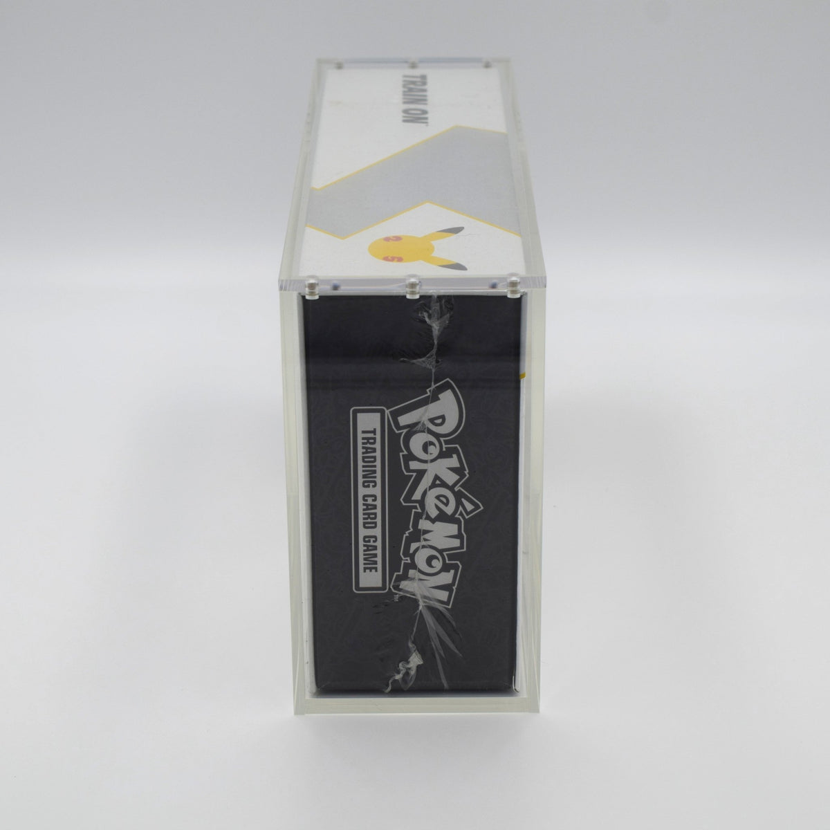 Acrylic case for a Pokémon Celebrations UPC, on a display shelf